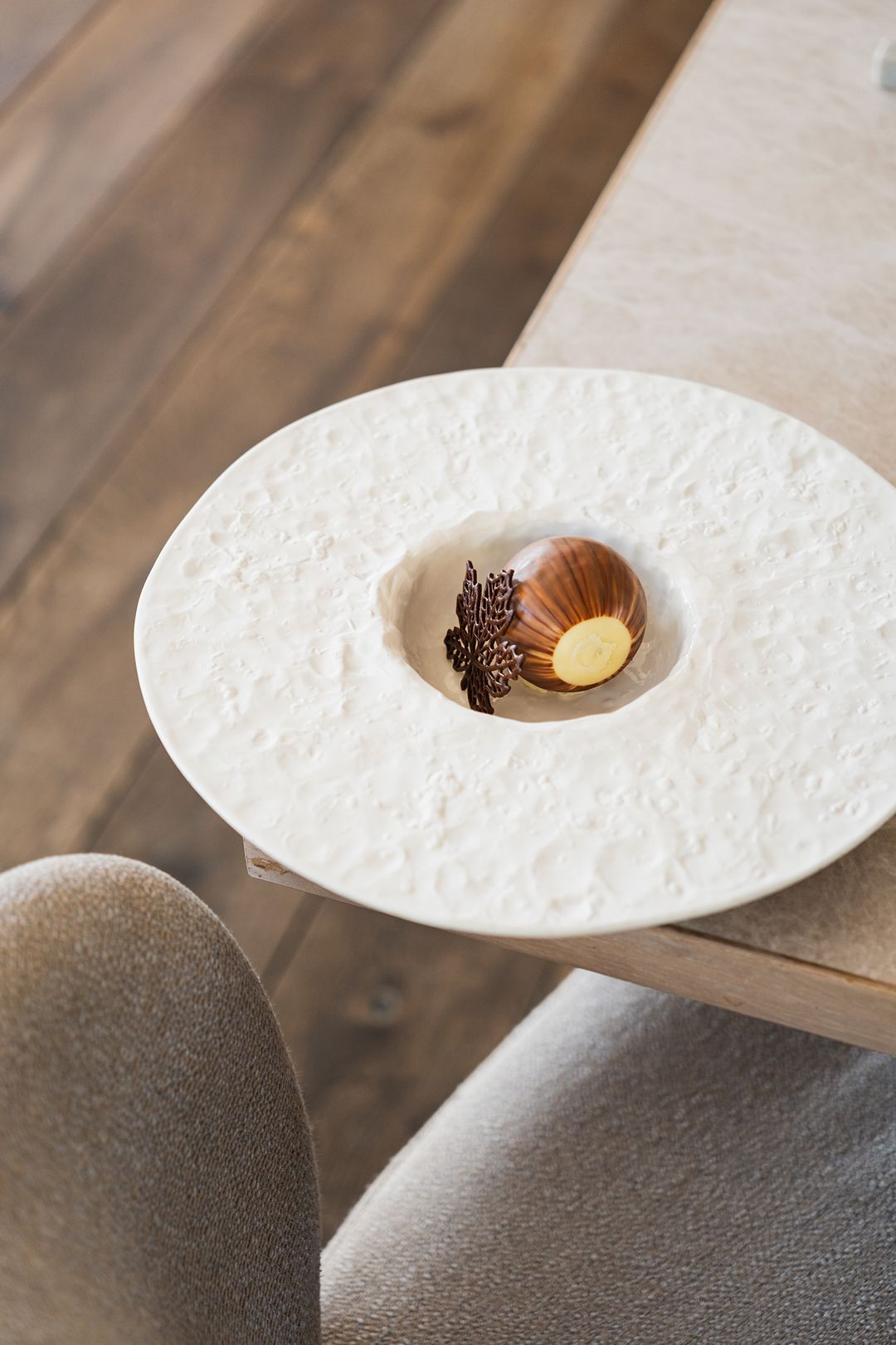 Hazelnut dessert on a white plate at the table, Przystań & Marina