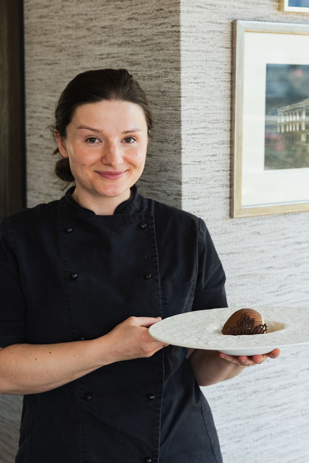 Przystań & Marina kitchen team member with the hazelnut dessert